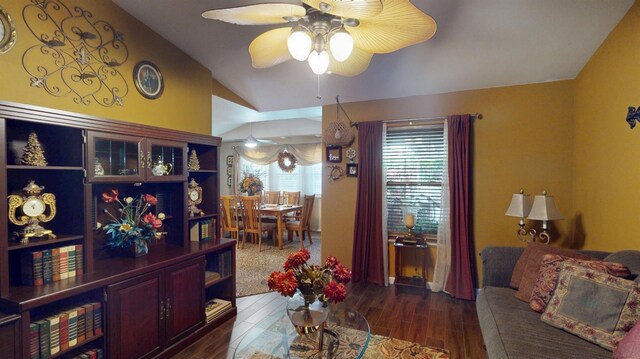 living room featuring wood finished floors, ceiling fan, and lofted ceiling