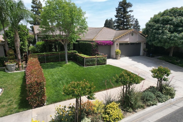 view of front of home with a garage, a front lawn, a tiled roof, and driveway