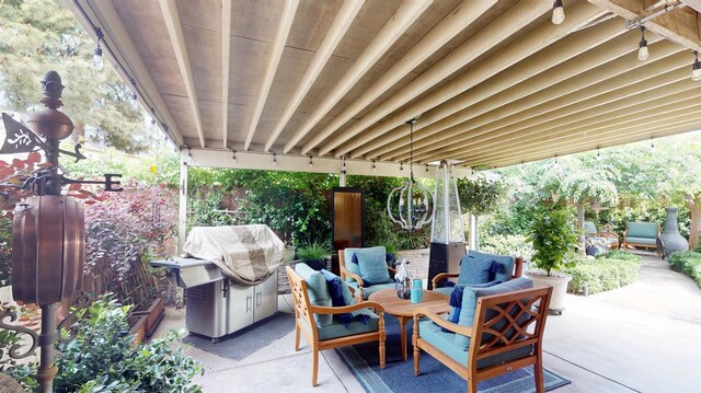 view of patio / terrace featuring fence, an outdoor living space, and a grill