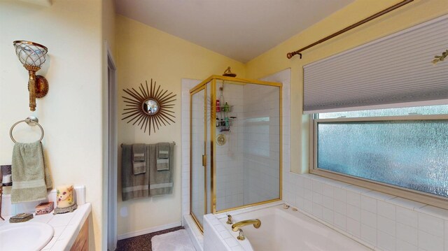 full bathroom featuring a garden tub, baseboards, vanity, and a shower stall