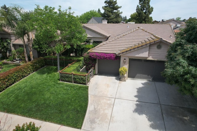 view of front of house with a tiled roof, a garage, a front lawn, concrete driveway, and stucco siding