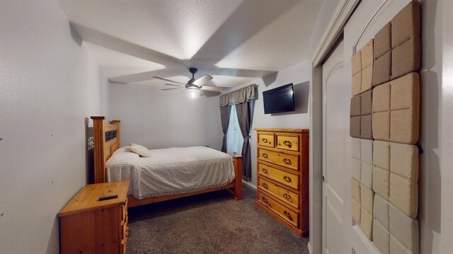 bedroom featuring ceiling fan and dark colored carpet