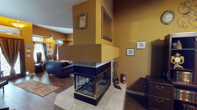 interior space with baseboards, visible vents, and wood finished floors