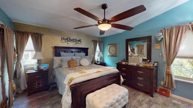bedroom featuring baseboards, a ceiling fan, and wood finished floors
