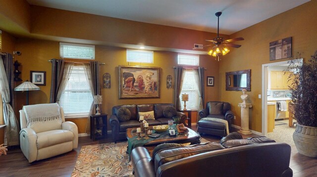living room with a healthy amount of sunlight, baseboards, ceiling fan, and wood finished floors