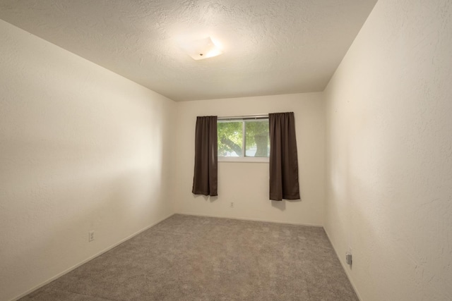 6352 N Fisher St, Fresno, CA 93710 - carpeted empty room with a textured ceiling