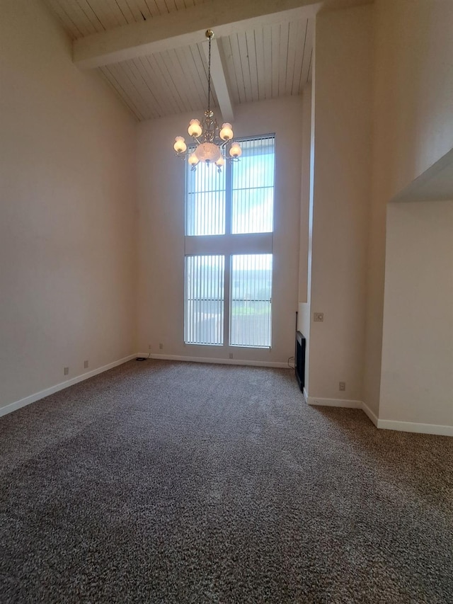 carpeted empty room featuring baseboards, a notable chandelier, and beamed ceiling