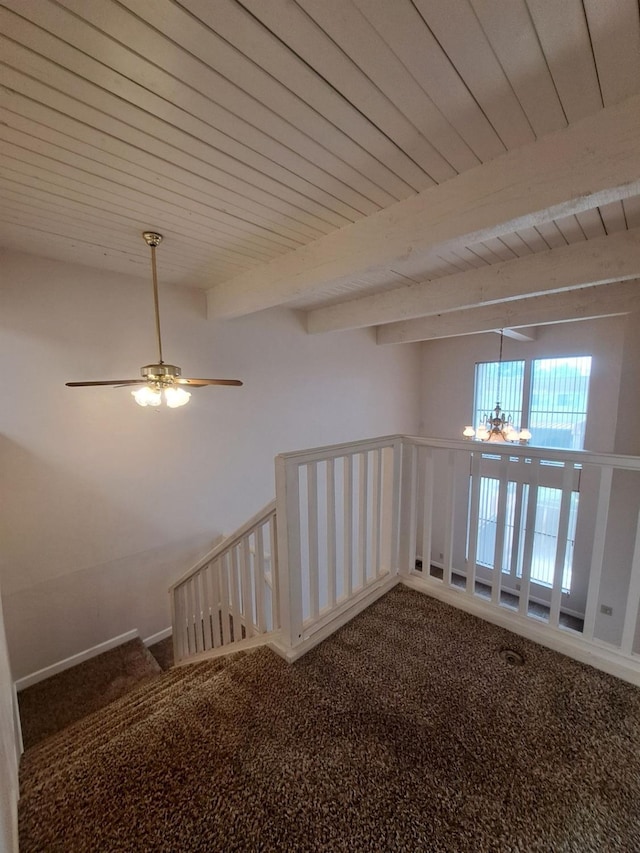 interior space featuring beamed ceiling, carpet, and ceiling fan with notable chandelier