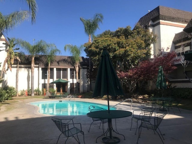 outdoor pool with a patio area