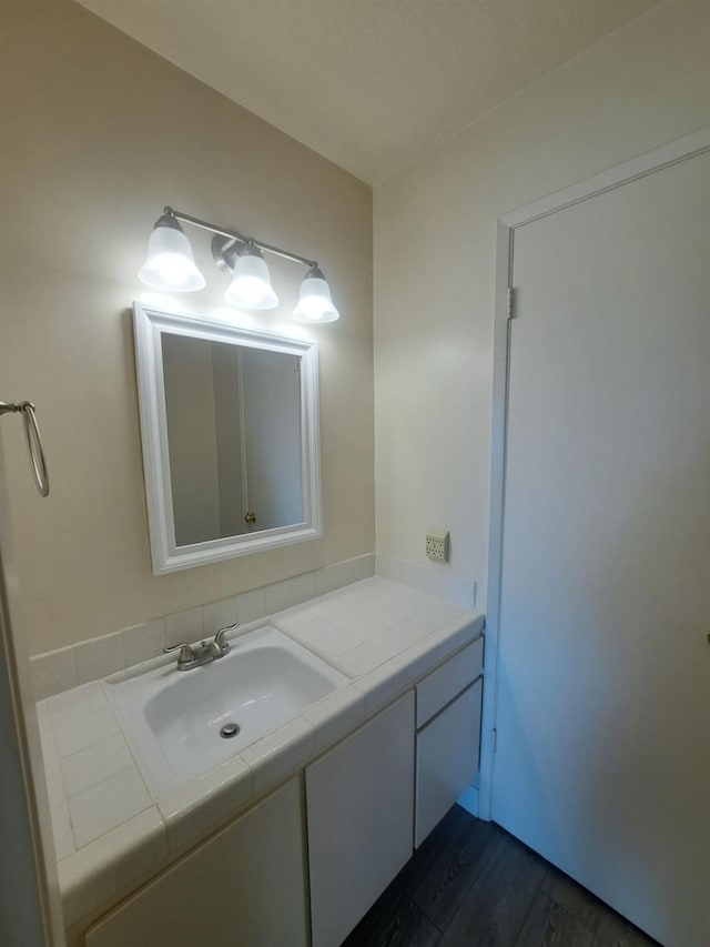 bathroom featuring wood finished floors and vanity
