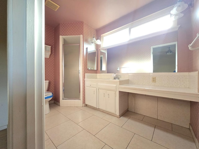bathroom with toilet, wallpapered walls, visible vents, and a stall shower