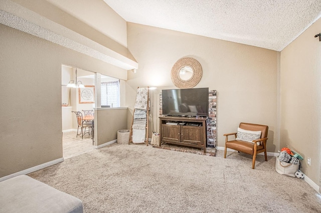living area featuring a textured ceiling, vaulted ceiling, baseboards, and carpet