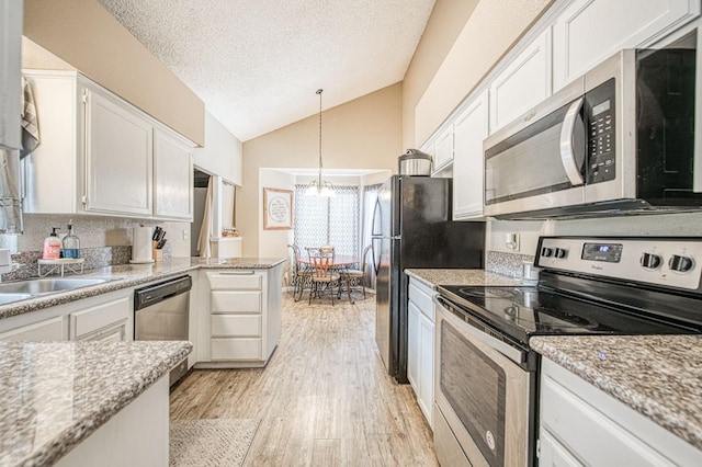 kitchen with light wood-type flooring, a textured ceiling, white cabinets, appliances with stainless steel finishes, and a notable chandelier