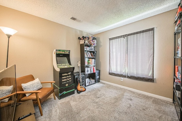sitting room featuring a textured ceiling, baseboards, visible vents, and carpet