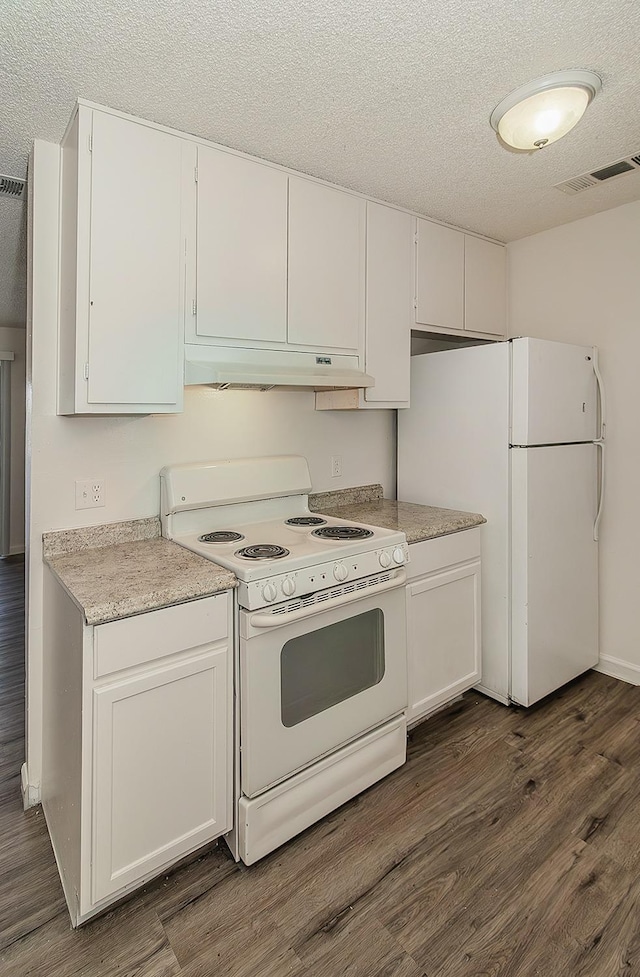 kitchen featuring white appliances, a textured ceiling, under cabinet range hood, and dark wood-style floors