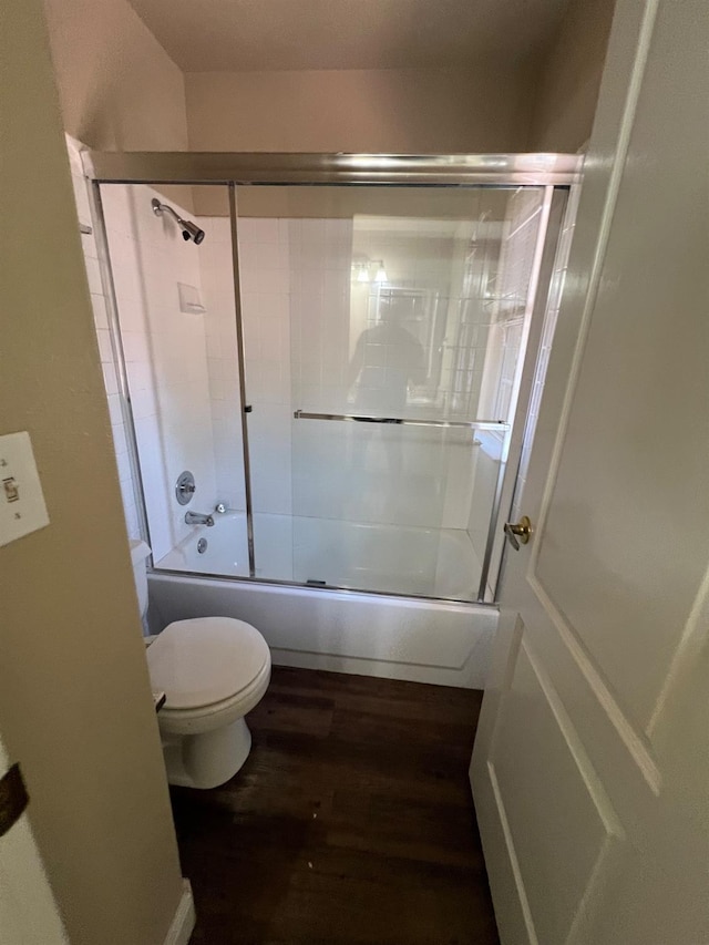 bathroom with shower / bath combination with glass door, toilet, and wood finished floors