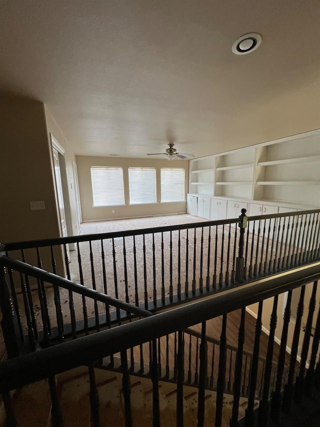 stairway with ceiling fan