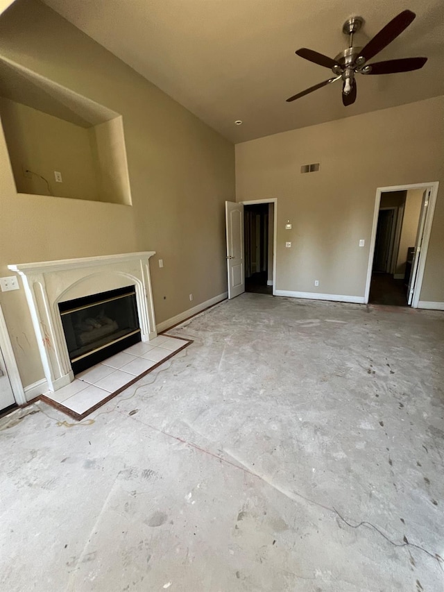 unfurnished living room with ceiling fan, visible vents, a fireplace with flush hearth, and baseboards