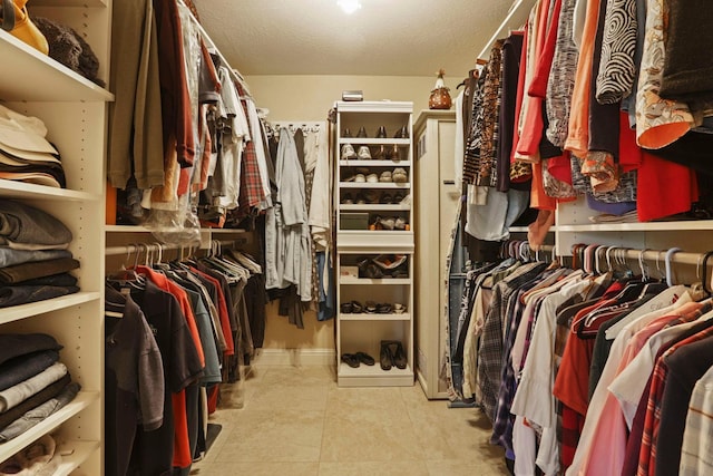spacious closet featuring tile patterned floors