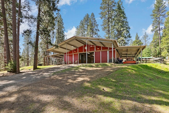 view of pole building with a lawn and driveway