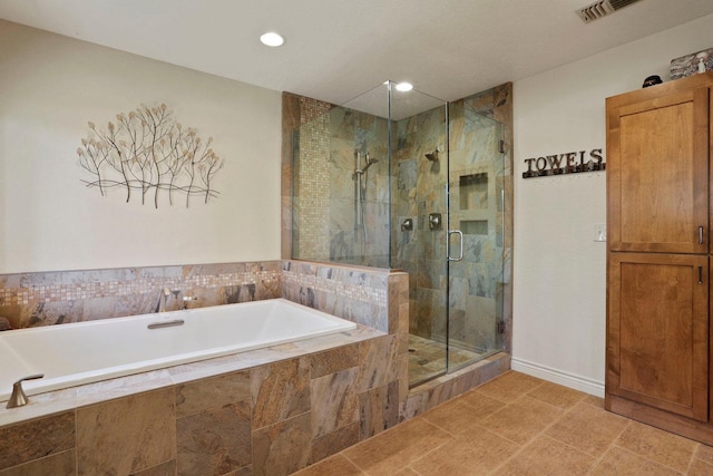 bathroom featuring recessed lighting, baseboards, visible vents, a bath, and a stall shower