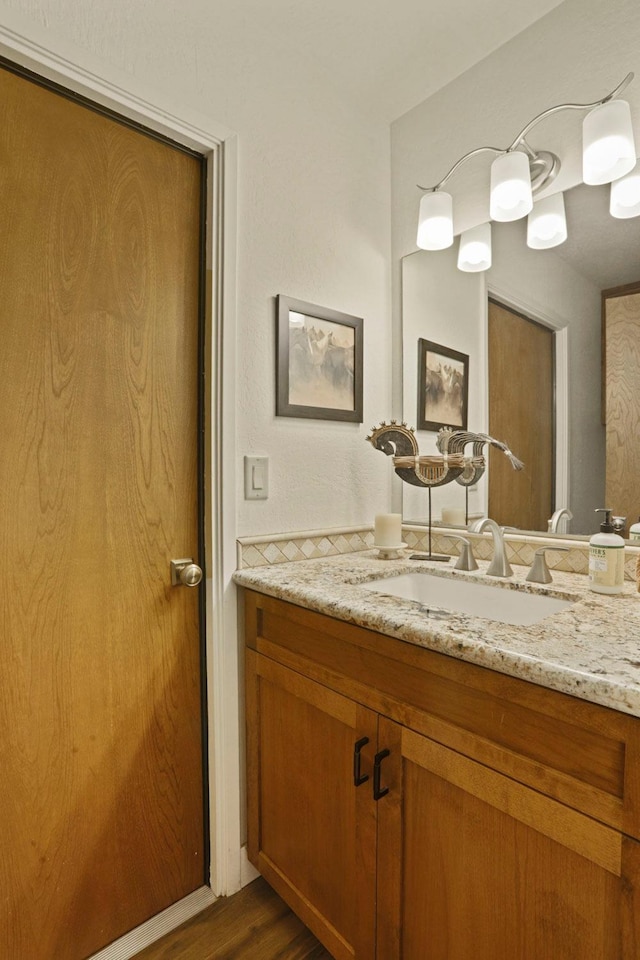 bathroom with vanity and wood finished floors