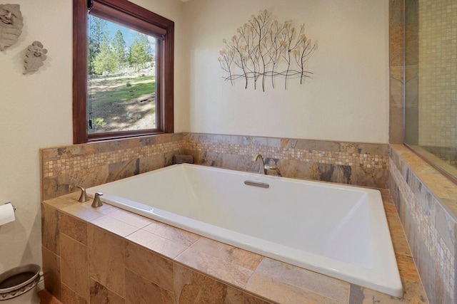 full bathroom with tiled bath