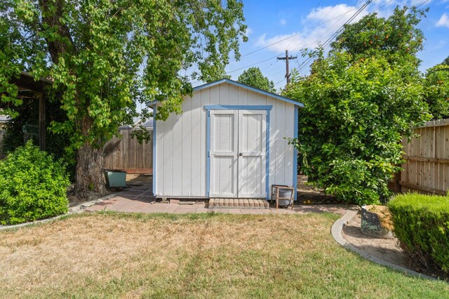 view of shed featuring fence private yard