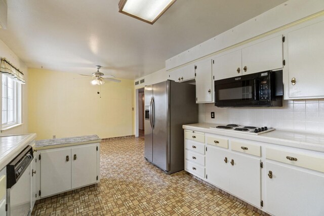 kitchen with white appliances, a ceiling fan, white cabinetry, backsplash, and visible vents