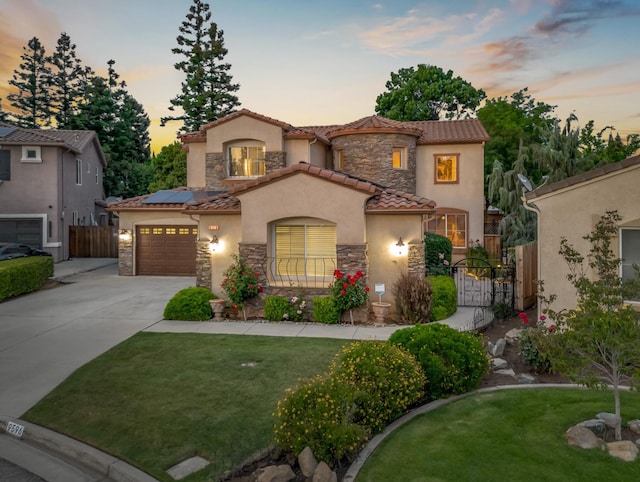 9596 N Winery Ave, Fresno, CA 93720 - mediterranean / spanish-style home with a gate, stucco siding, concrete driveway, and stone siding