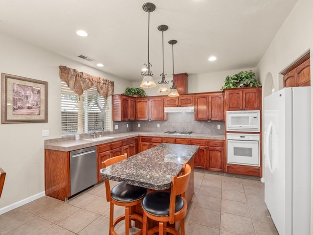 9596 N Winery Ave, Fresno, CA 93720 - kitchen with visible vents, appliances with stainless steel finishes, a sink, light tile patterned floors, and under cabinet range hood