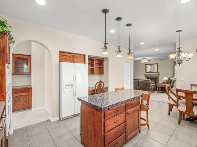 9596 N Winery Ave, Fresno, CA 93720 - kitchen featuring light tile patterned flooring, white refrigerator with ice dispenser, a fireplace, a center island, and recessed lighting