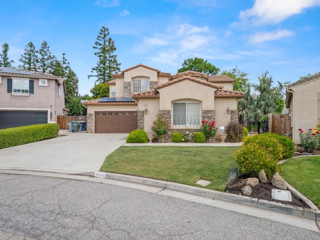 9596 N Winery Ave, Fresno, CA 93720 - mediterranean / spanish-style home with driveway, solar panels, stone siding, and stucco siding