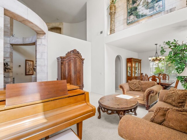 9596 N Winery Ave, Fresno, CA 93720 - interior space with carpet floors, visible vents, an inviting chandelier, a towering ceiling, and arched walkways