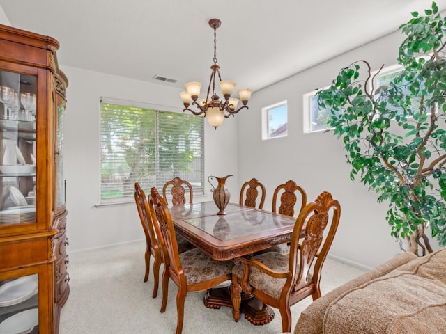 9596 N Winery Ave, Fresno, CA 93720 - dining room featuring visible vents, baseboards, a chandelier, and light carpet