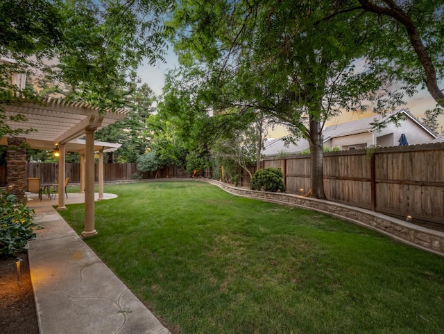 9596 N Winery Ave, Fresno, CA 93720 - yard at dusk featuring a patio, a pergola, and a fenced backyard
