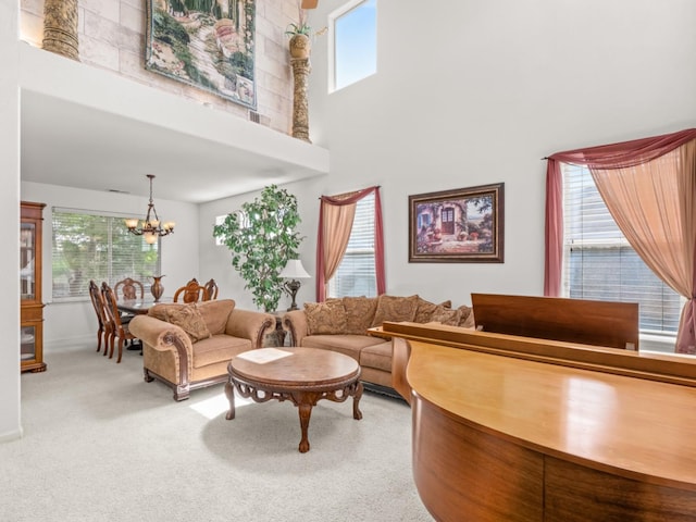9596 N Winery Ave, Fresno, CA 93720 - living area featuring light colored carpet, baseboards, a high ceiling, and a notable chandelier