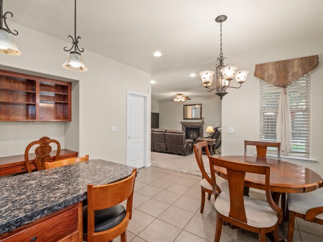 9596 N Winery Ave, Fresno, CA 93720 - dining room with a fireplace, light colored carpet, recessed lighting, a chandelier, and light tile patterned floors