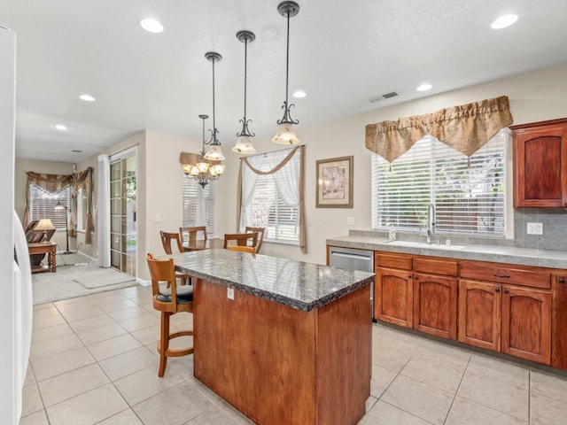 9596 N Winery Ave, Fresno, CA 93720 - kitchen with a sink, light tile patterned floors, a kitchen island, and visible vents