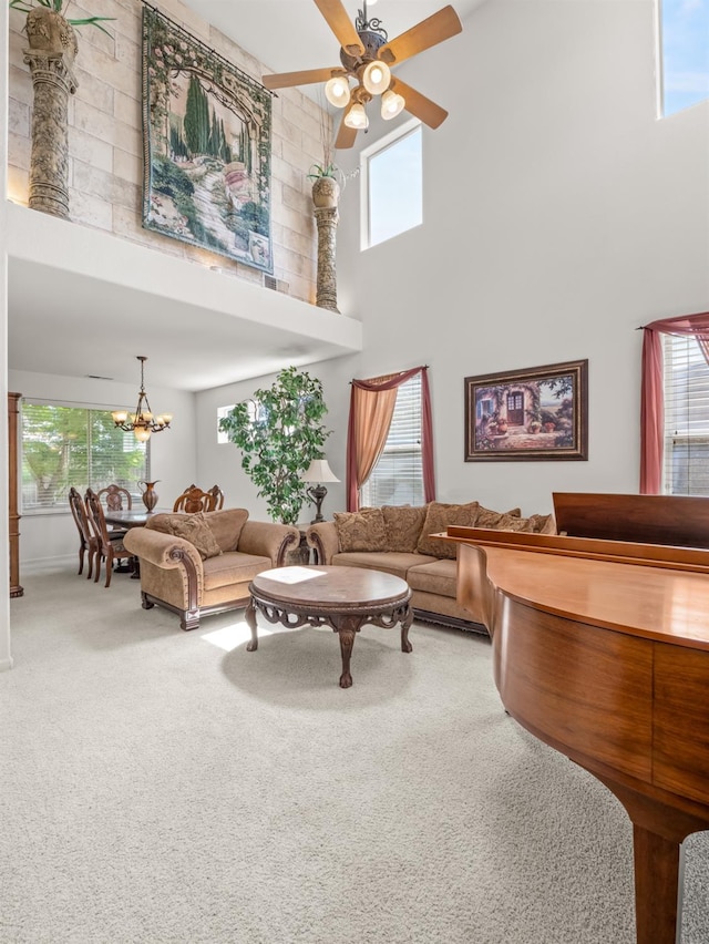9596 N Winery Ave, Fresno, CA 93720 - carpeted living area featuring a healthy amount of sunlight, ceiling fan with notable chandelier, and a towering ceiling