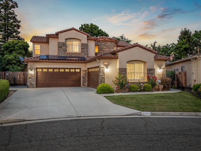 9596 N Winery Ave, Fresno, CA 93720 - mediterranean / spanish-style house with fence, a tile roof, stone siding, and stucco siding