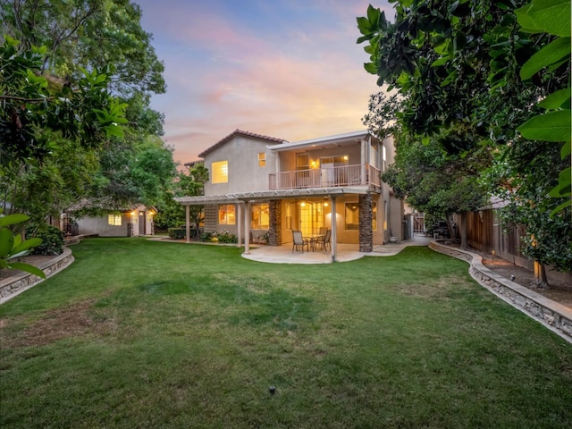 9596 N Winery Ave, Fresno, CA 93720 - rear view of house with a balcony, a fenced backyard, a yard, a patio, and stucco siding