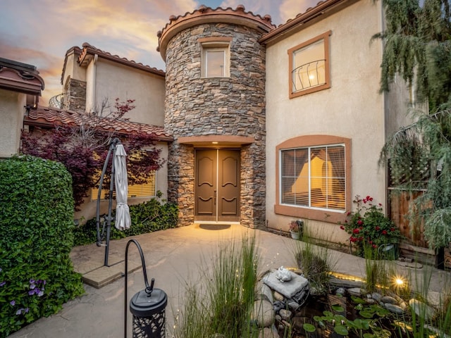 9596 N Winery Ave, Fresno, CA 93720 - view of front of property with stucco siding, a tiled roof, stone siding, and fence