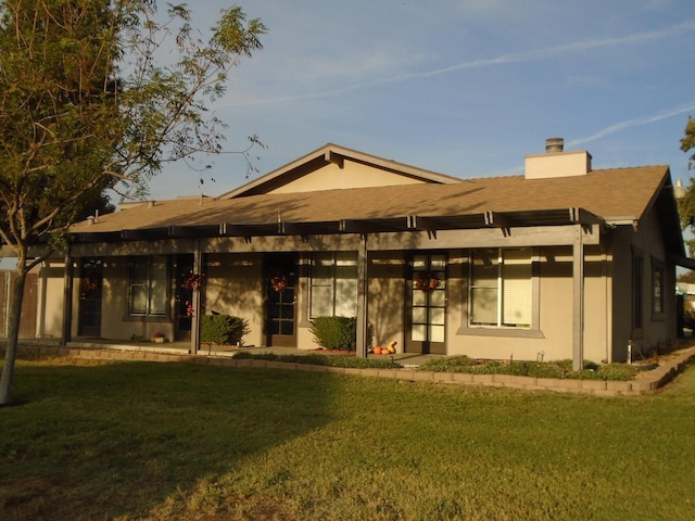 860 E Grangeville Blvd Unit 153, Hanford, CA 93230 - view of front of home with a front lawn, a chimney, and stucco siding