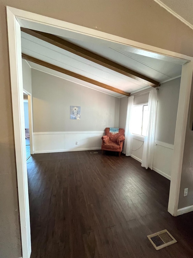 860 E Grangeville Blvd Unit 153, Hanford, CA 93230 - unfurnished room featuring beam ceiling, dark wood-style floors, and a wainscoted wall