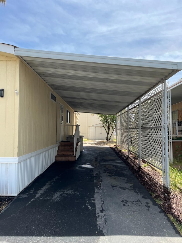 860 E Grangeville Blvd Unit 153, Hanford, CA 93230 - view of vehicle parking featuring an attached carport and asphalt driveway