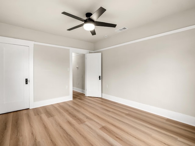 unfurnished bedroom featuring visible vents, a ceiling fan, light wood finished floors, and baseboards