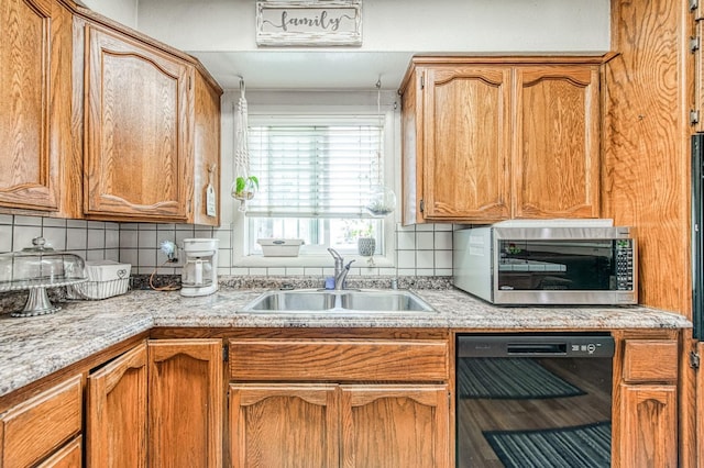kitchen with a sink, light countertops, stainless steel microwave, and dishwasher