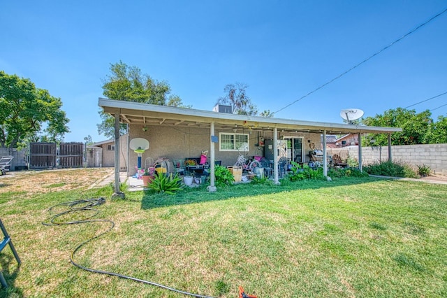 rear view of property with a lawn, a patio, a fenced backyard, and stucco siding