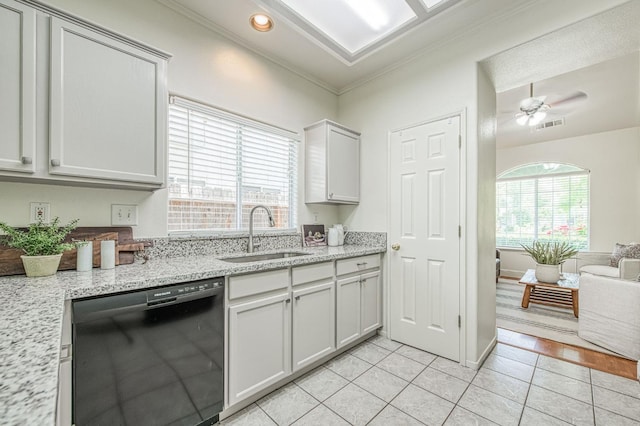 kitchen featuring visible vents, crown molding, dishwasher, a sink, and light tile patterned floors